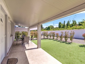Relax in a shaded outdoor space with comfortable seating and dining areas.
