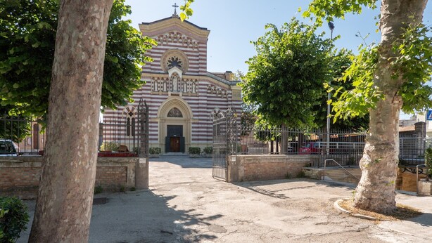 A church with a central dome and arched entrance, surrounded by trees and a paved courtyard. - Holiday Home in Fano Near the Beach (Fano)