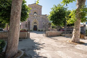 A church with a central dome and arched entrance, surrounded by trees and a paved courtyard. - Holiday Home in Fano Near the Beach (Fano)