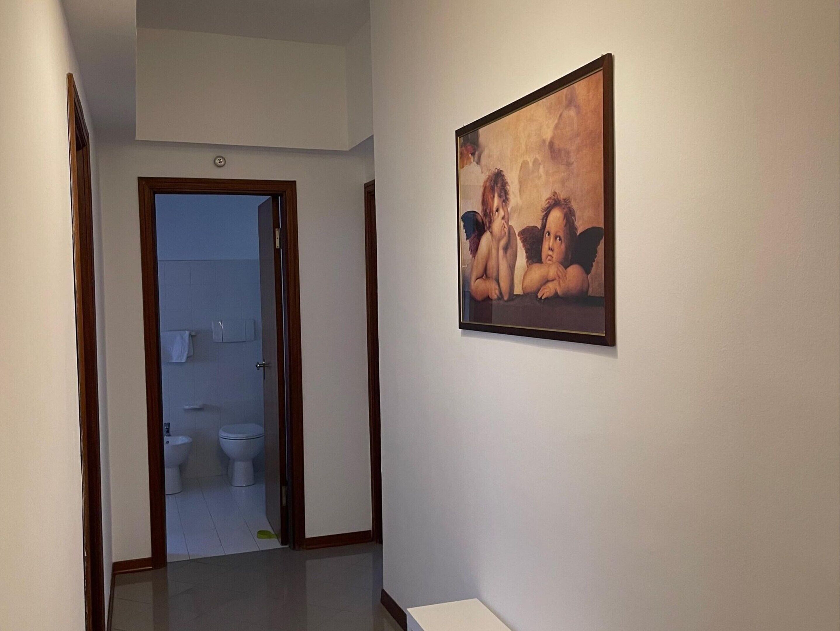 A hallway with a door leading to a bathroom.