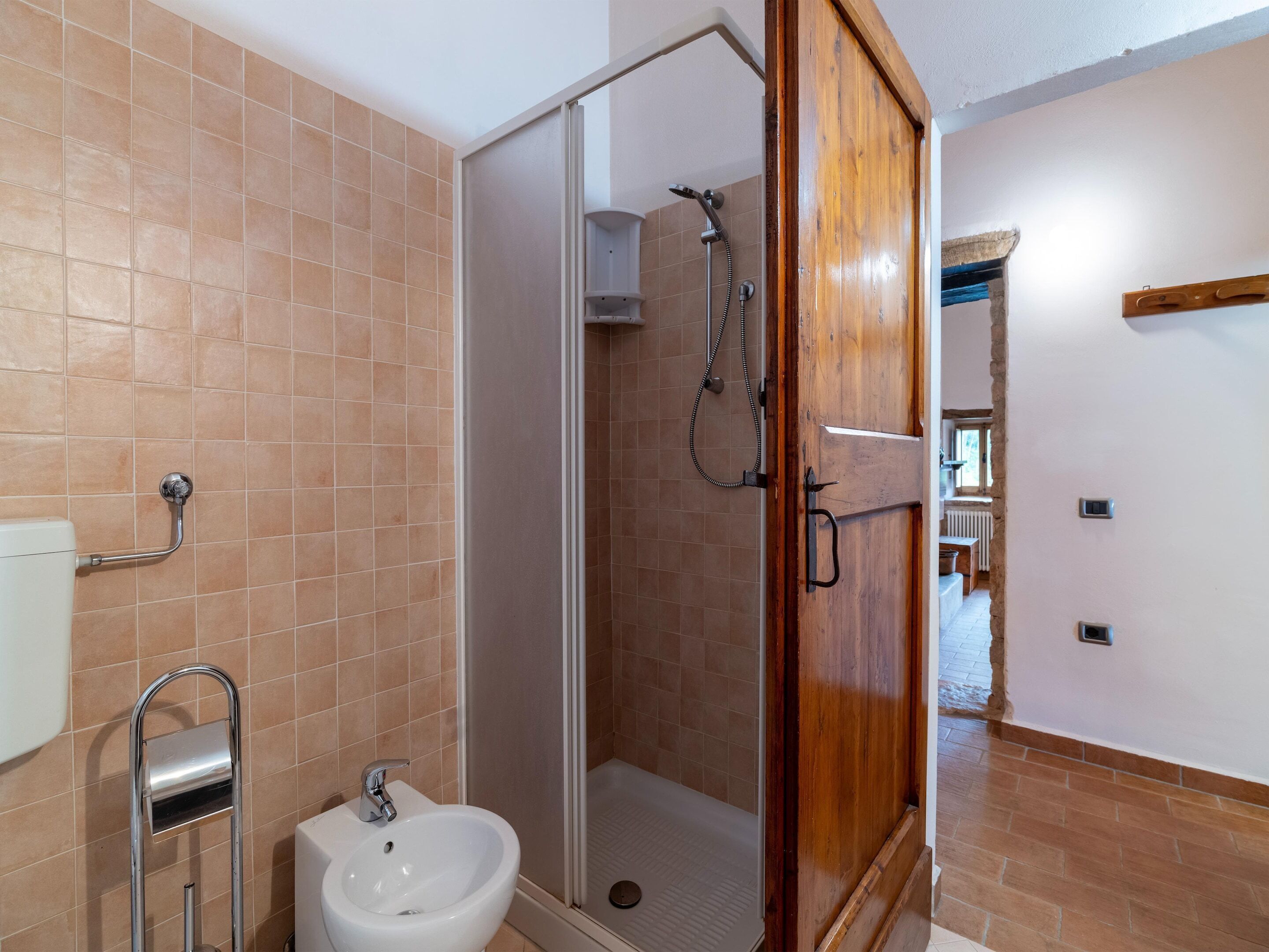 A bathroom with a shower, a sink, and a toilet.