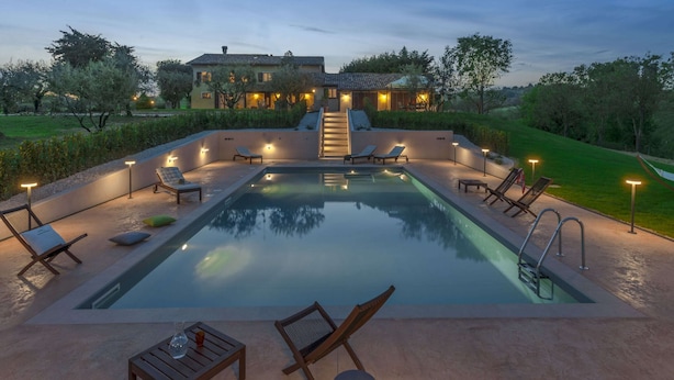 A swimming pool with lounge chairs and a staircase leading to a house. - Holiday Home With Swimming Pool, San Costanzo (San Costanzo)