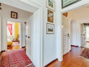 A hallway with white doors, a red patterned rug, and framed pictures on the walls. - Lavish Castle in Riedenburg with Garden near Lake (Riedenburg)