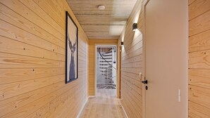 A wooden hallway with a staircase leading to a second floor. - Elegant Chalet in Manhay With Sauna (Manhay)