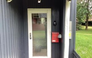 A door with a glass panel, a mailbox, and a small mailbox on the wall. - 5 Person Holiday Home in Hovborg (Hovborg)