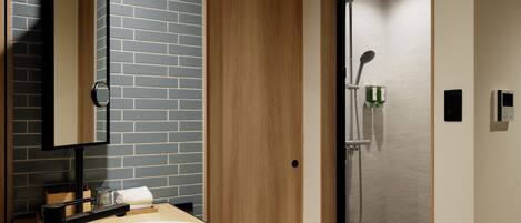 Un baño moderno con un lavabo redondo, un espejo, cabina de ducha y una puerta de madera.