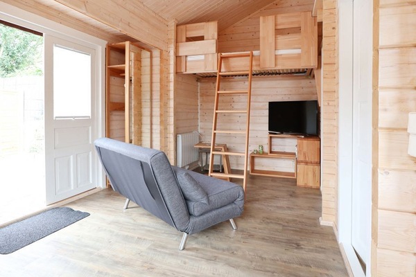 Malmö Blockhaus - Blick auf das Schlafsofa, den TV