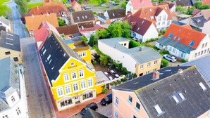 A yellow building with a sign indicating it is a hotel. - Double room - Hotel Zur Mühle Ziegler family (Kappeln)