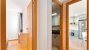 A modern kitchen with wooden cabinets, a stainless steel refrigerator, and a built-in oven. - Bright duplex, consisting of two joined flats (two bedroom + studio) that fit 5 people (Barcelona)