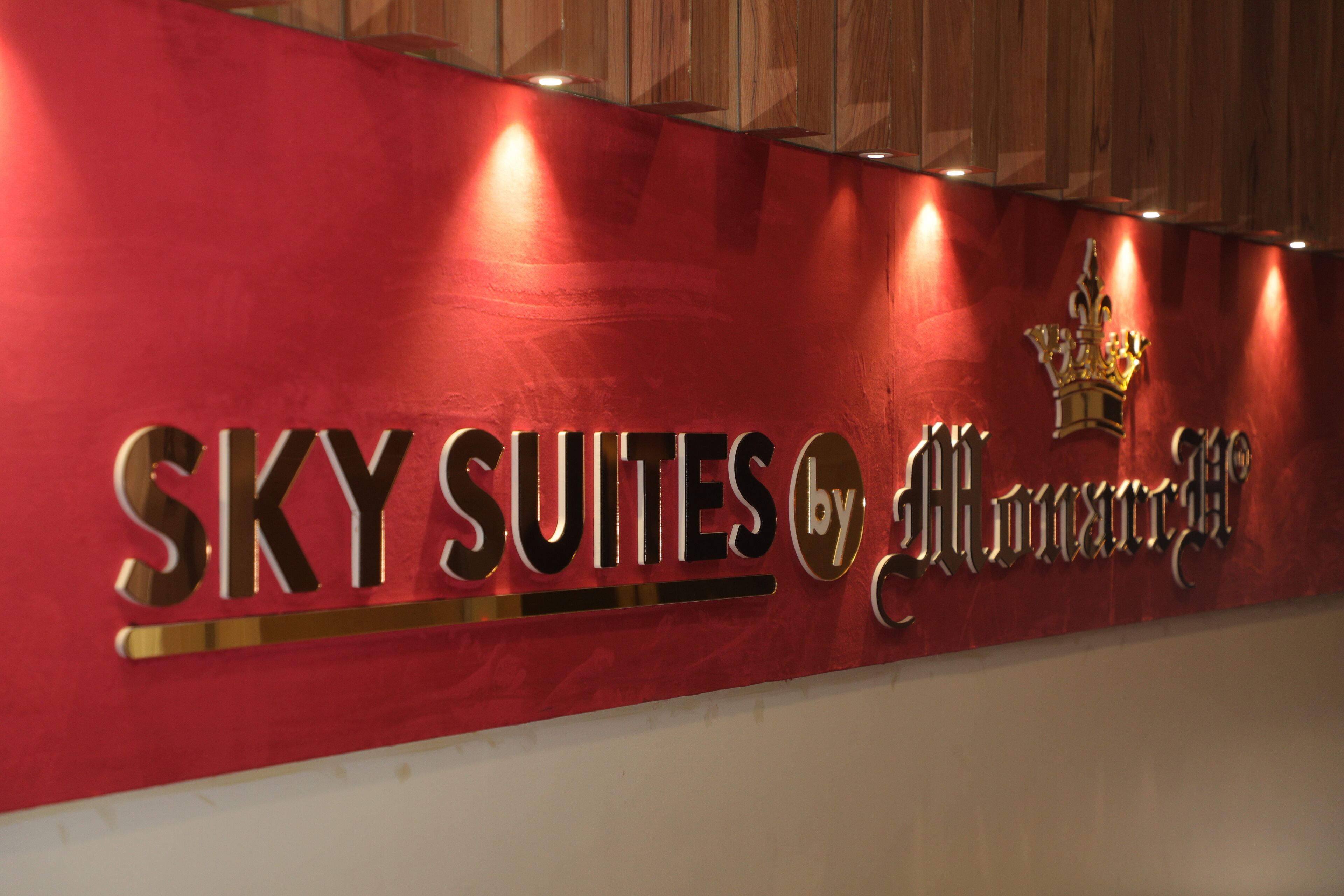 A sign for "SKY SUITES by Almaral" with a crown emblem.