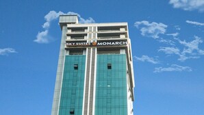 A tall building with the sign "Sky Suites Monarch" at the top. - Sky suites by Monarch (Navi Mumbai)