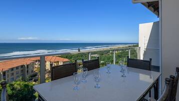 Enjoy a glass of wine on the balcony overlooking the ocean and beach.