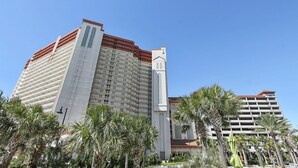 A high-rise hotel with multiple balconies and a prominent tower section. - Family Perfect with Lagoon pool and Crystal Sand Beach! (Panama City Beach)