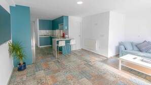 A modern apartment with a kitchen, a dining area, and a living room. - Suncastle Lovely Attic! (Alicante/Alacant)