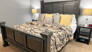 A bedroom with a dark wood bed, two bedside tables with lamps, and a headboard with a decorative panel. - Fortunata Casa Del Sole Private House and Poolside Escape (Aubrey)