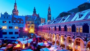 A historic building with multiple arches and a covered market area. - "If you want to enjoy life, move to Striesen." (Dresden)