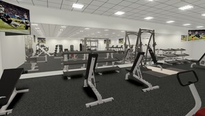 A gym with various exercise equipment, including treadmills, weight machines, and a squat rack. - The Armadillo Hotel (Odessa)