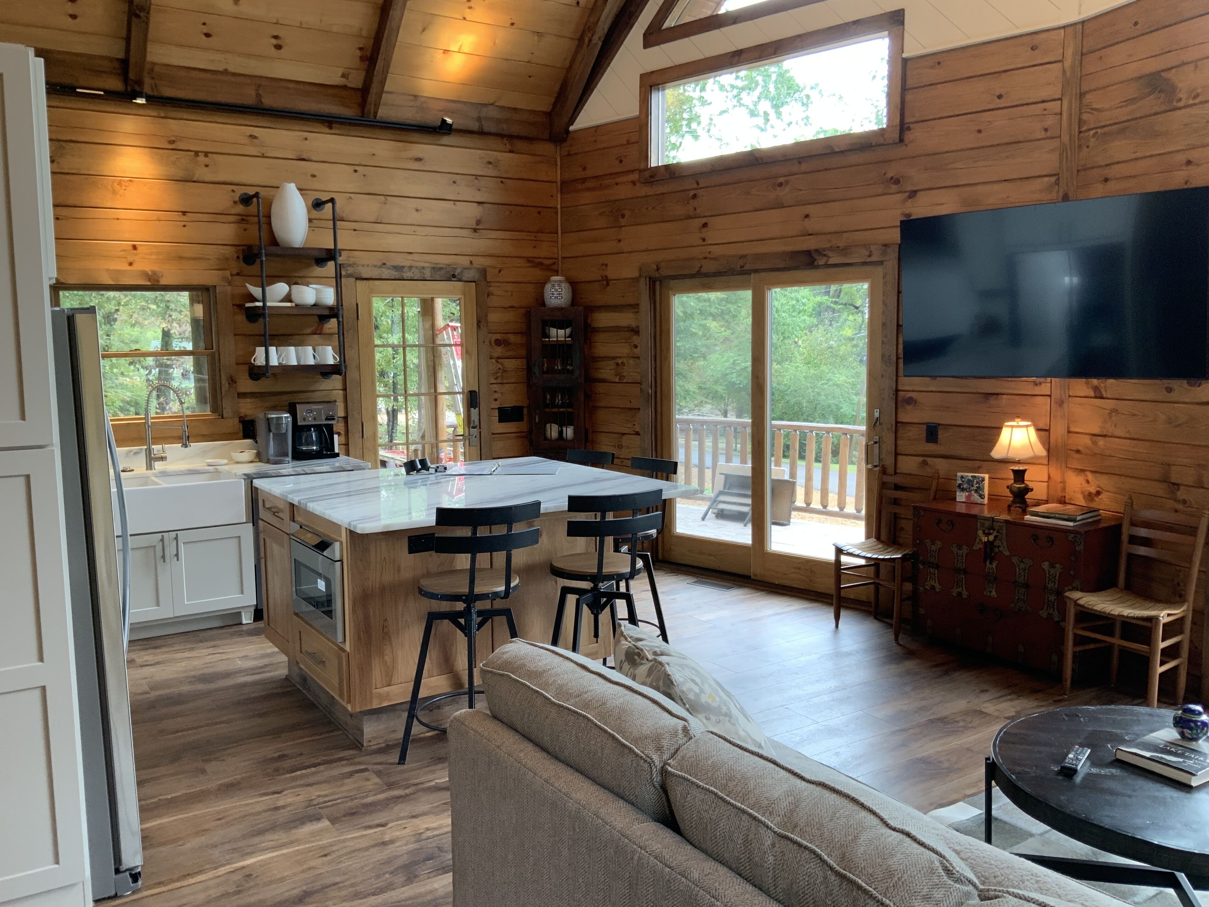 A cabin interior with a kitchen, dining area, and living room.