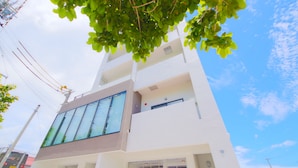 A modern building with large windows and a flat roof. - Sakuraya (Okinawa)