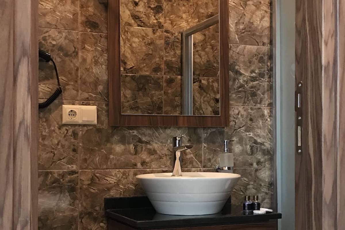 superior room | bathroom | shower, rainfall showerhead, hair dryer, slippers