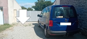 A blue Volkswagen van parked in a driveway.