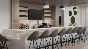 A modern bar area with a long counter, multiple stools, and a flat-screen TV mounted on the wall. - Element by Marriott Seattle Sea-Tac Airport (Tukwila)