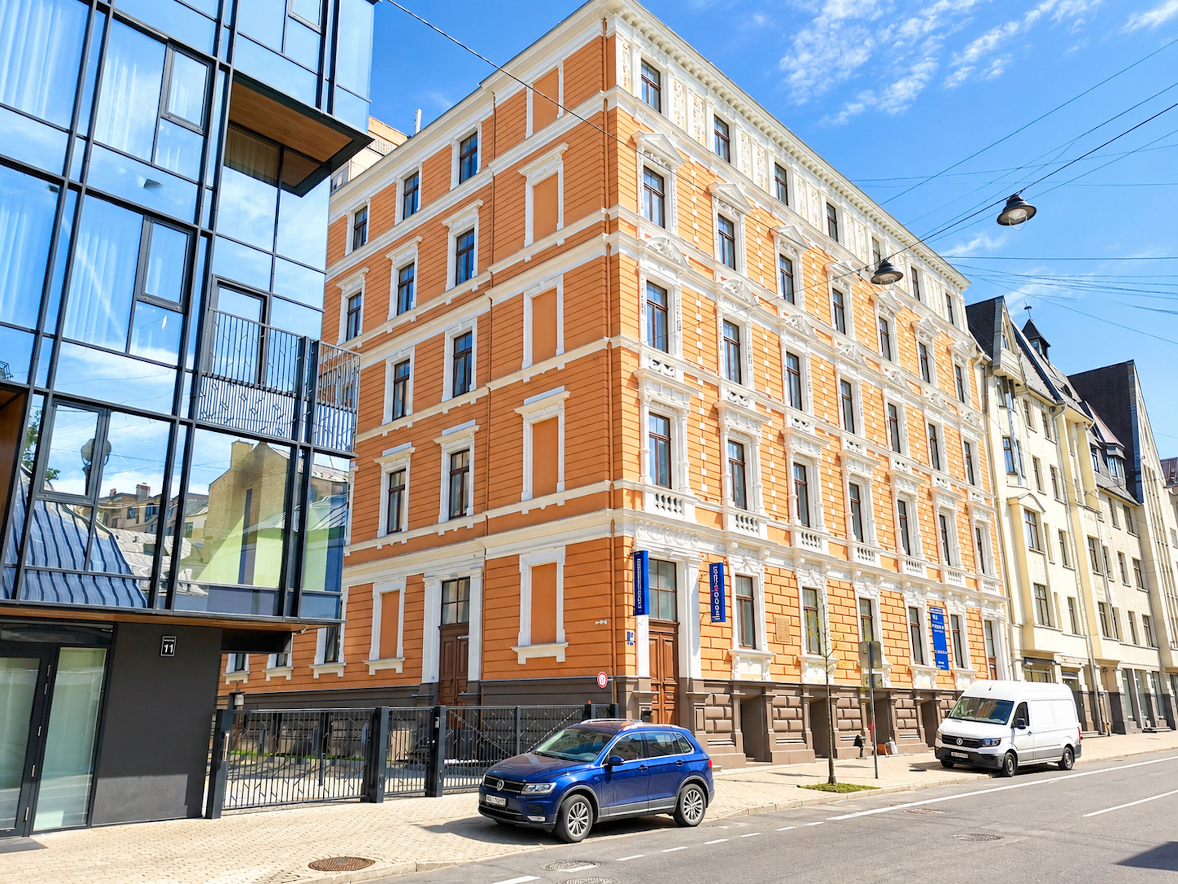 A multi-story building with a brick facade and large windows.
