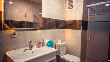 Standaard eenpersoonskamer | Badkamer | Een douche, een haardroger, pantoffels, handdoeken