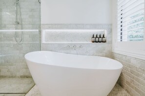 Bathtub, hair dryer, towels, soap