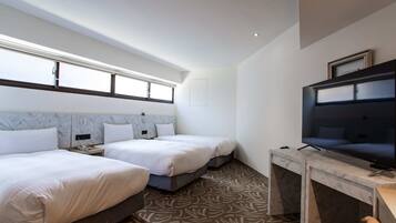 A hotel room with two beds, a television, and a marble-patterned floor.