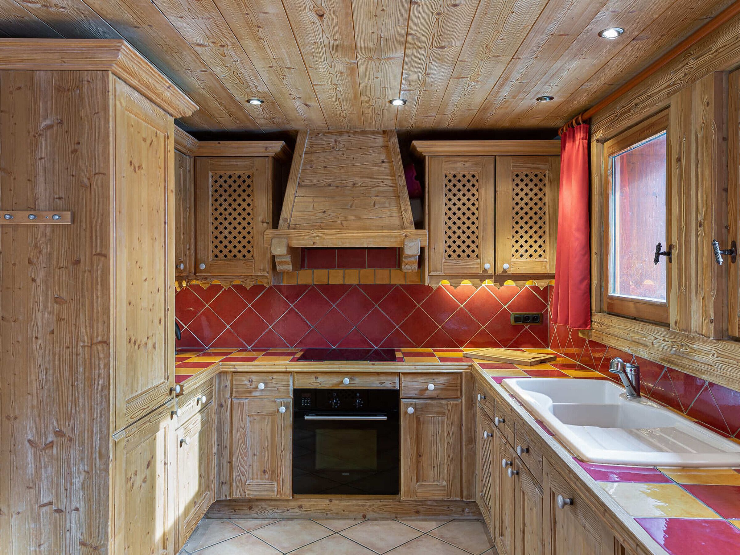 A kitchen with wooden cabinets, a tiled backsplash, and a built-in oven.