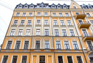 A multi-story building with ornate architectural details, large windows, and balconies.