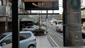 A sign for 'B&B YUIGAHAMA' with a direction to '2F front desk'. - B&B Yuigahama (Kamakura)