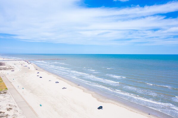 Enjoy a serene beach experience with gentle waves lapping at the shore.