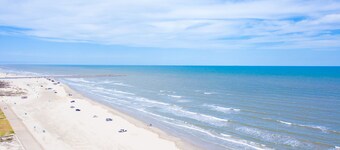 Spacious family home with patio, steps away from the beach with a pool onsight!