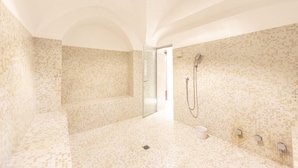 A modern bathroom with mosaic tile walls and floor, a glass shower enclosure, and a bathtub. - Hotel Müller Mountain Lodge (Pontresina)
