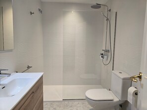 Bathtub, hair dryer, towels, toilet paper