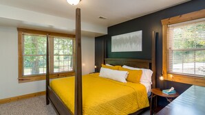 A bedroom with a four-poster bed, large windows, and a painting on the wall. - Blue Spruce . Trailside Lodging (Millersburg)