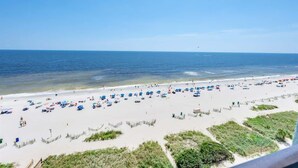 A beach with numerous umbrellas and people. - Amazing  Beachfront Views, Decorated and Renovated (Myrtle Beach)