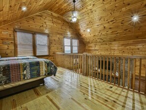 A wooden cabin bedroom with a bed, windows, and a balcony. - Hazy Horizons by Mountain Oasis | 4 state long-range views (Blue Ridge)