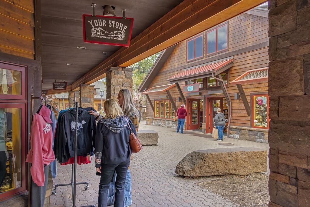 A rustic wooden building with a sign reading "YOUR STORE" and a covered walkway leading to it.
