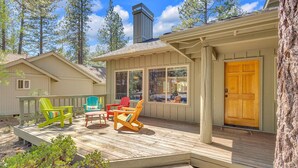 A wooden deck with Adirondack chairs, a small porch, and a door. - Awbrey Lane 2 (Bend)