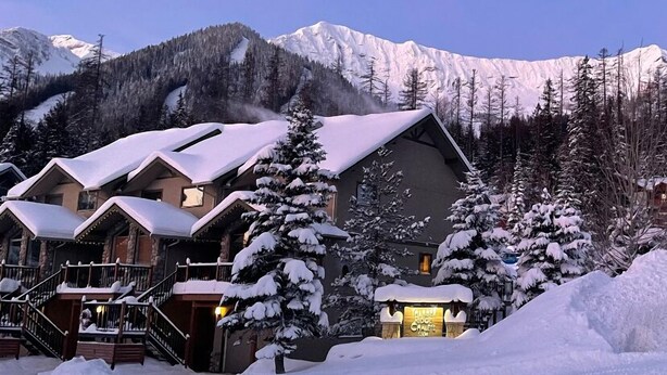 A lodge with multiple buildings, a snow-covered landscape, and mountains in the background. - Fernie Alpine Resort accommodation Thunder Ridge Chalet Truely Ski in/Ski out  (Fernie)