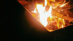 Fuego ardiendo dentro de un contenedor metálico.
