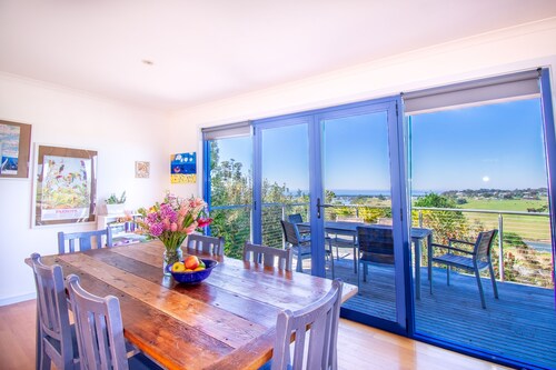 A two- story house with sweeping views of Bass Strait and  the North Arm.  