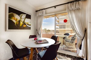 Enjoy a meal at the round table with a view of the city from the balcony.
