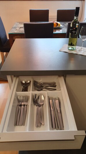 A dining table with a bottle of wine and a glass on it. - Wiener Maisonette mit Terrasse (Wien)