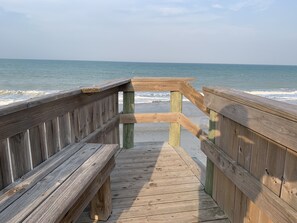 A wooden boardwalk leading to a beach with waves in the background. - Enjoy our Private Beach Access! (Vero Beach)