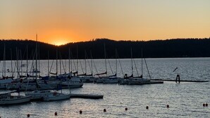 A marina with several sailboats docked at low tide.
