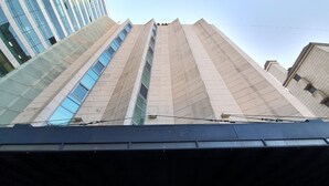 Un edificio moderno con una entrada destacada y un cartel que indica que es el Hotel 048.